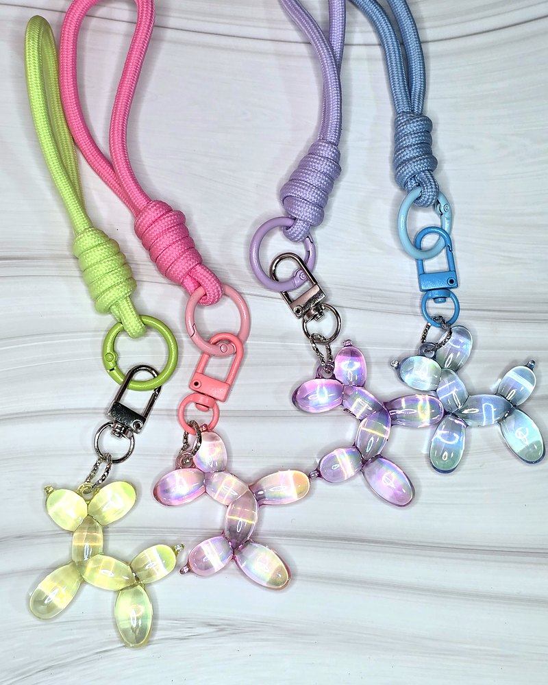 Iridescent balloon-dog charms on pastel wrist straps