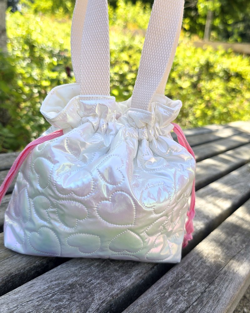 Handmade iridescent heart-quilted bag with a woven handle